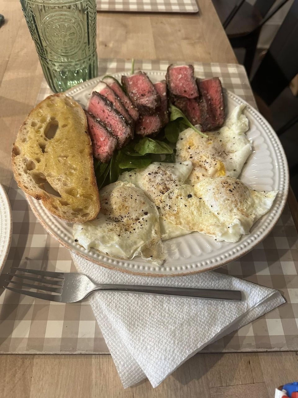 Grass-fed steak and pastured eggs on a plate